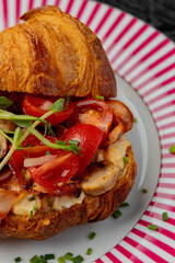 Croissant with filling on a beautiful plate isolated