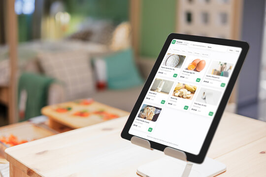 Closeup tablet computer with online shopping mall list products household grocery online store