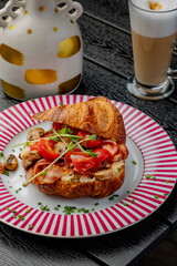 Croissant with filling on a beautiful plate isolated