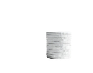 A stack of white, ridged coins against a stark black background