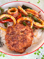  Rice topped with stir fried minced pork and basil. Stir fried curry paste in Thailand.