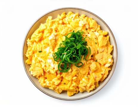 Bowl of scrambled eggs topped with green onions, overhead