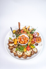 Top view of meat platter with pomegranate and veggies. Captures generosity and elegance