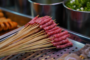 cantonese sausage in skewers in stainless tray for barbecue