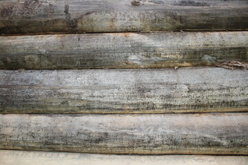 beautiful natural wooden logs stacked in a row