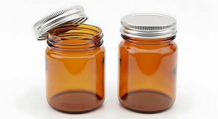 Two amber glass jars with metal lids isolated on white background