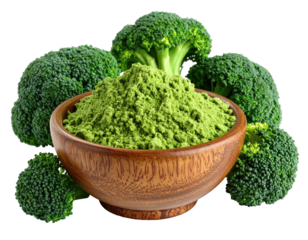 Fresh broccoli florets encircle a wooden bowl filled with green powder