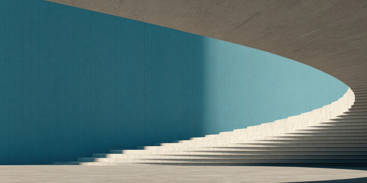 Man walking up a modern minimalist concrete spiral staircase with a teal wall