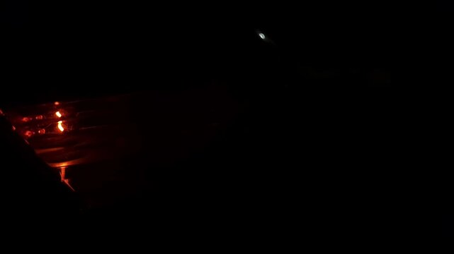 Slow motion Close up of a car's blinker indicating the direction change at night