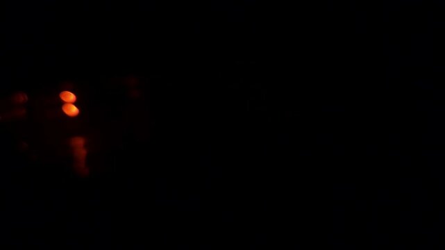 Slow motion Close up of a car's blinker indicating the direction change at night