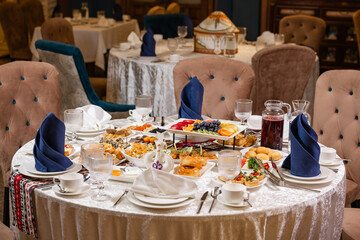 Top view of table with meat, salads, and desserts.