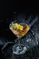 Elegant Cocktail Splash with Fresh Garnishes in Black Background