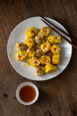 Delicious Assorted Dimsum on White Plate with Tea and Chopsticks