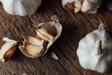 Fresh Garlic Bulbs and Cloves on Rustic Wooden Surface