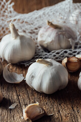 Fresh Garlic Bulbs and Cloves on Rustic Wooden Surface