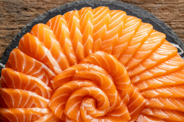 Artistic Arrangement of Salmon Sashimi on Black Slate Plate