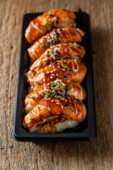Delicious Sushi Platter with Grilled Salmon and Garnish Display