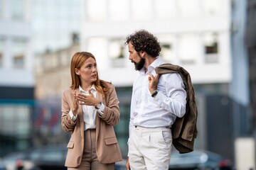 Businesspeople discussing work outdoors in urban setting