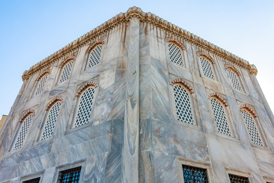 Architectural detail of historical marble building with ornate arched windows