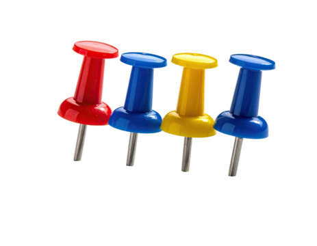 Close-up of four colorful pushpins on a black background
