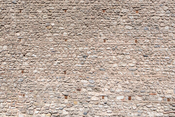 Stone brick wall texture with rough surface and mixed mortar