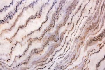 Close-up of natural beige marble texture with brown veins
