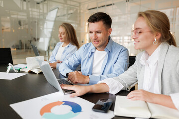 Obraz premium Collaboration among three professionals at a modern office workspace