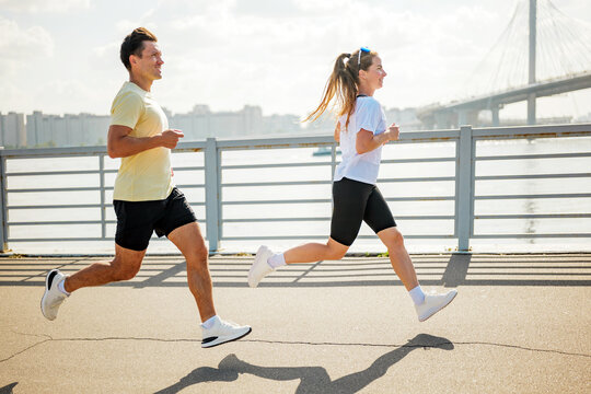 Running along the riverside with friends during a sunny afternoon workout - Powered by Adobe