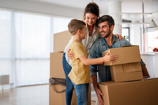 Fototapeta Happy family with child moving with boxes in a new apartment house. Mortgage, real estate investment