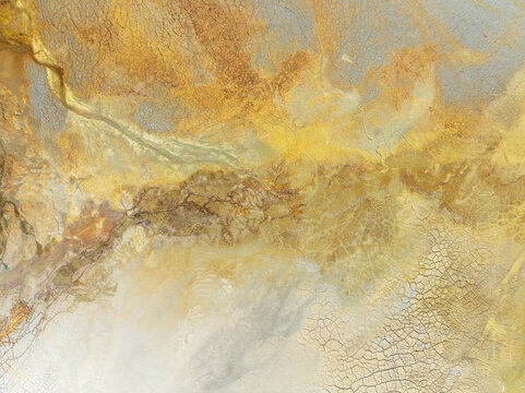 Aerial view of swirling, ochre-stained earth reveals the dramatic textures and mineral-rich landscapes of Minas de Riotinto, Andalusia, Spain.