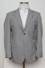 Elegant gray plaid blazer on a mannequin