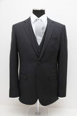 Elegant black suit displayed on a mannequin