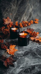 Black candles styled with autumn leaves and berries create a moody seasonal scene perfect for Halloween decor and dark fall aesthetics.
