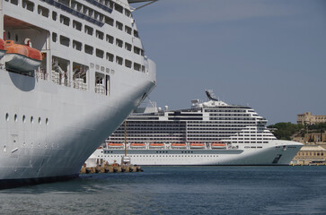 Modern cruise ship cruiseship liner being modernized over-hauled repaired refitted maintenanced by shipyard in Malta with dock and cranes