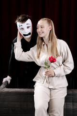 A loving mime expresses his feelings to a beautiful woman on a theater stage. Close-up.