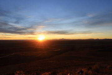 sunset view to the Salar de Uyuni Salt Flats in Bolivia from a viewpoint near the town Uyuni