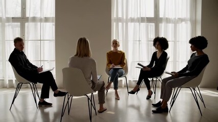 Young multi ethnic couple attending psychotherapy session with professional psychologist in modern, bright office, discussing relationship issues and seeking guidance for a healthier dynamic