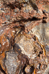 Textured background of natural relief sandy stone.Ideal for use in architectural, geological, or nature-themed projects.