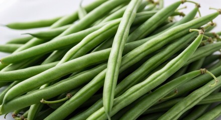Obraz premium Pile of fresh green beans, angled shot, close-up, bright, on white surface