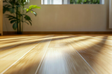 Warm sunlight illuminates a smooth wooden floor in a cozy room filled with greenery, creating a serene atmosphere