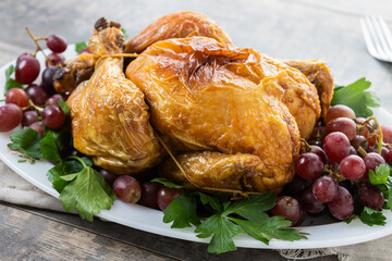Roast turkey with grapes and parsley for thanksgiving dinner on wooden table