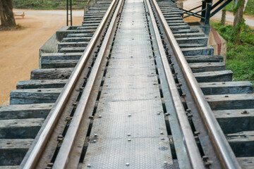 Fototapeta premium Rail track with wooden sleepers and rusty rails at old railway bridge
