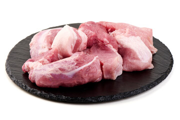 Raw Pork Chunks, Meat on Black Slate, isolated on white background