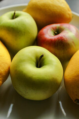 Fresh fruits lemons and apples plate