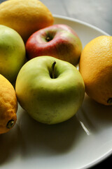 Fresh fruits lemons and apples plate