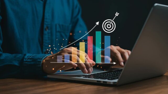 Businessman using laptop with business target and growth graph, symbolizing strategic planning, data analysis, and achieving financial goals through technology