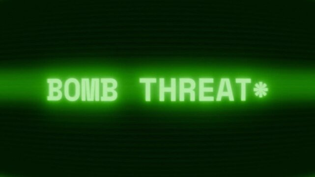 Old green CRT screen showing text BOMB THREAT! appearing in random glitch and coding style
