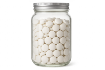 Pills filling clear glass jar with silver cap