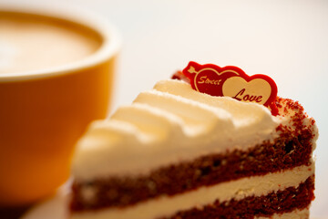 Homemade cake Red Velvet decorated with cream and cup of coffee