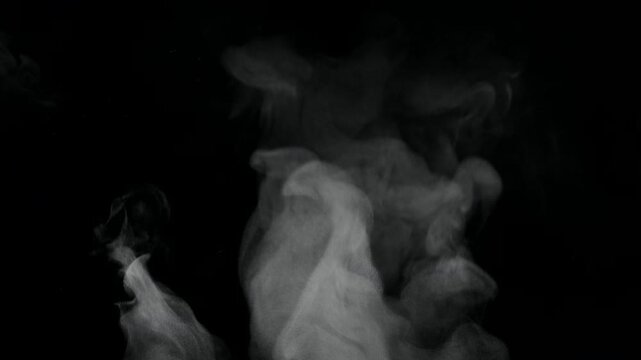 White natural rising steam from food or hot drink isolated on a black background. Сan be used in any projects with hot food.